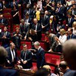 French members of Parliament applaud French Minister of Public Action and Accounts Gerald Darmanin (C) after a winning vote on public finance programming for 2018 - 2022 on October 24, 2017, at the French National Assembly in Paris. / AFP PHOTO / Eric FEFERBERG